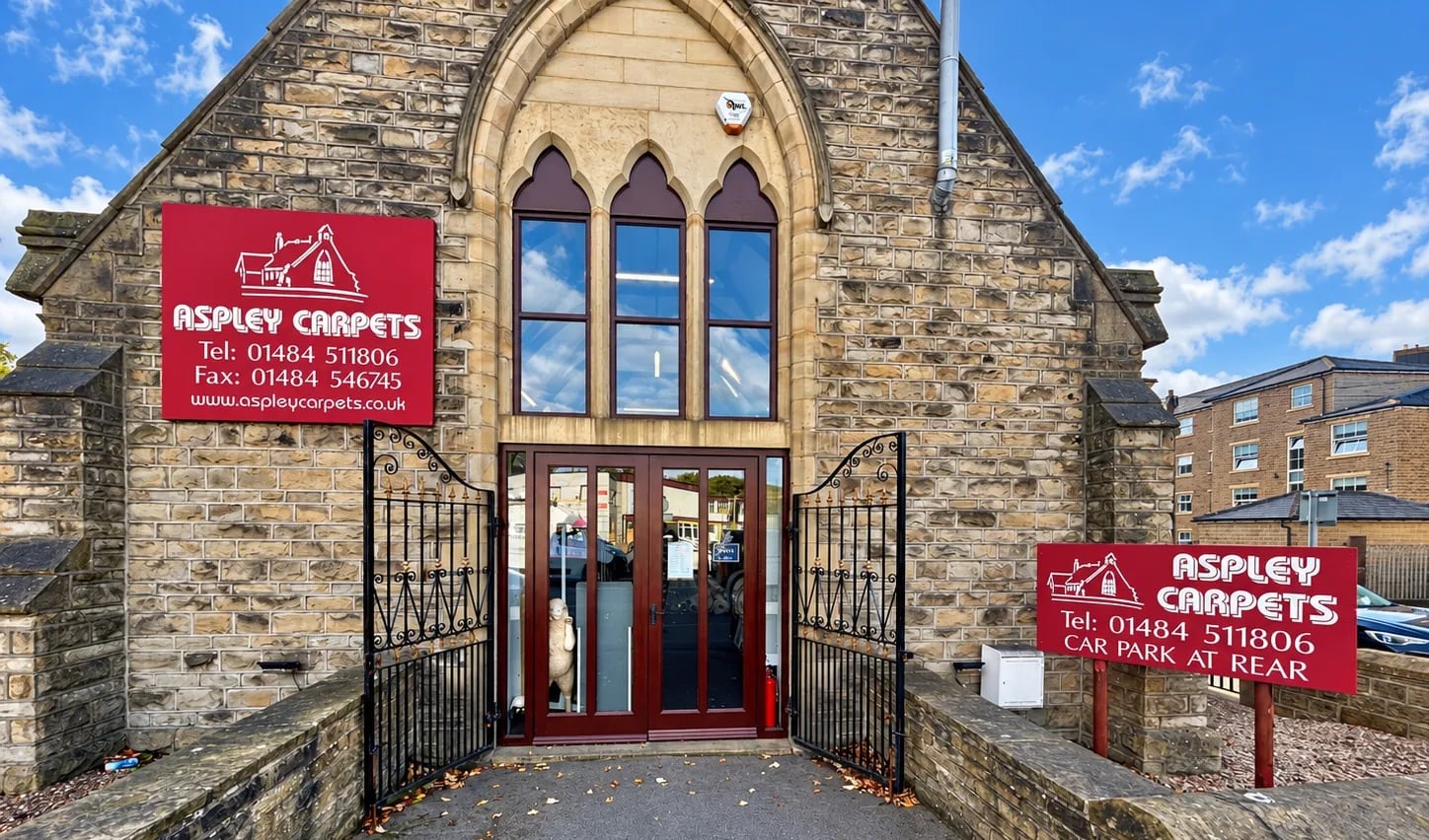 The stone-built Aspley Carpets showroom, with its red Aspley Carpets signs